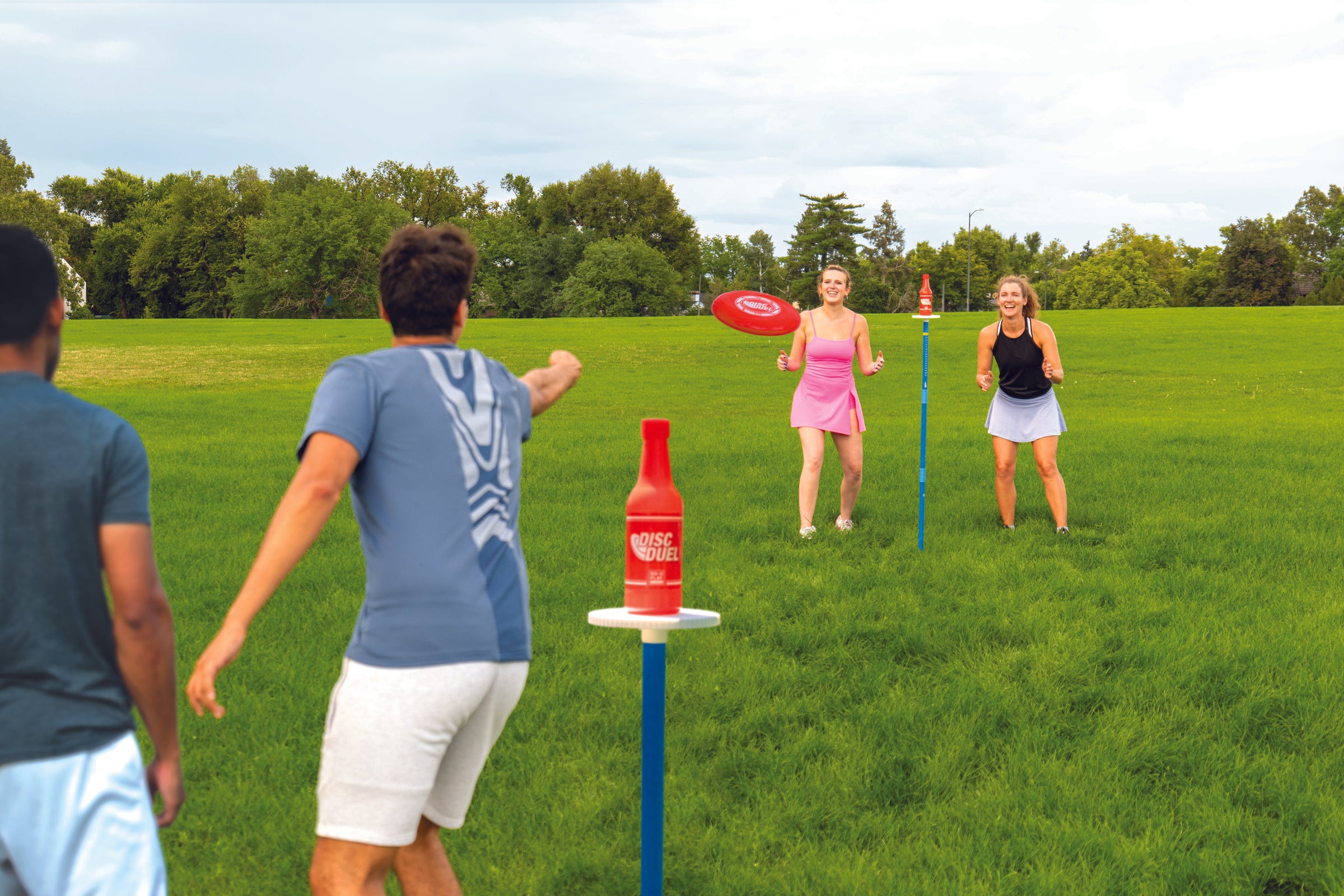 People playing a disc game at a tailgate party